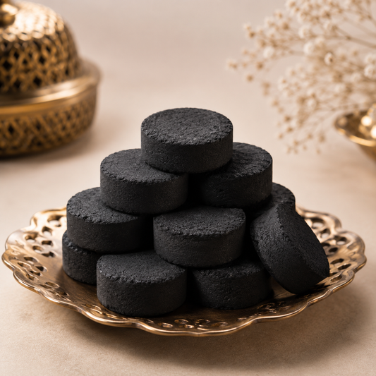 Oud Bakhoor — black Arabian incense discs on a brass plate by OUD REVE