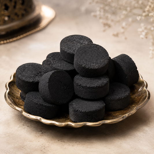 Vetiver Bakhoor — black Arabian incense discs on a brass plate by OUD REVE